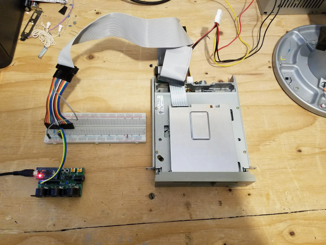 The final product: a 5.25 inch floppy connected by a ribbon cable to anArduino